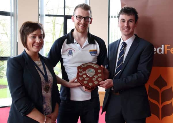 Mark Gibson, Trillick YFC receives the Senior Member of the Year trophy from the event sponsor United Feeds representative, Andrew McMordie and YFCU President, Roberta Simmons. Picture: Rachel Martin