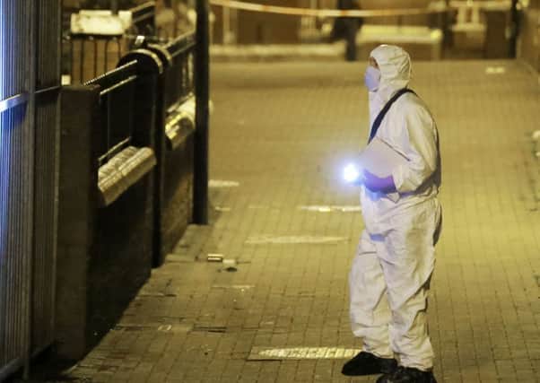 A forensic officer on the scene of last night's fatal shooting in north Belfast