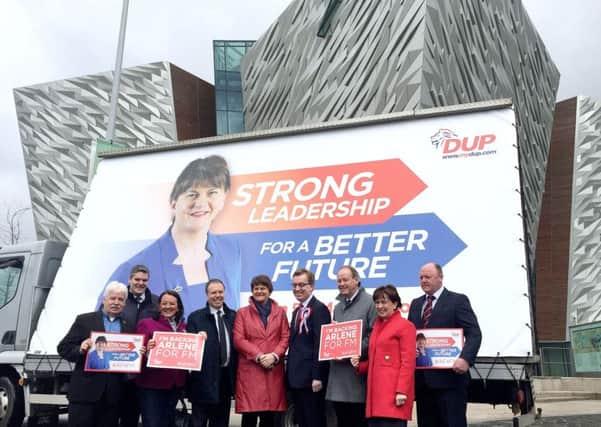 DUP leader Arlene Foster (centre) stands with with party colleagues 
during her party's election billboard launch outside Titanic Belfast.