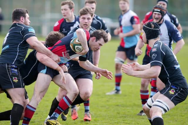 Belfast Harlequins' Mark Glover pushes forward against Ballymena's Chris Cundell