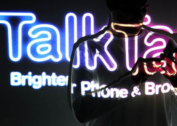 File photo dated 03/02/11 of the TalkTalk logo on a person using a phone, as a teenager has become the sixth person to be arrested in connection with the alleged data theft from TalkTalk
