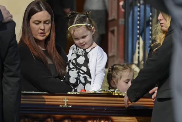Joanne McGibbon (wife) with her children during the funeral of Michael McGibbon at Holy Cross Church in the Ardoyne area of  North Belfast