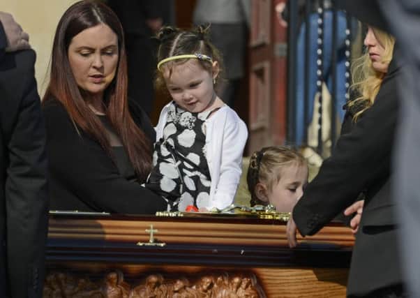 Joanne McGibbon (wife) with her children during the funeral of Michael McGibbon at Holy Cross Church in the Ardoyne area of  North Belfast