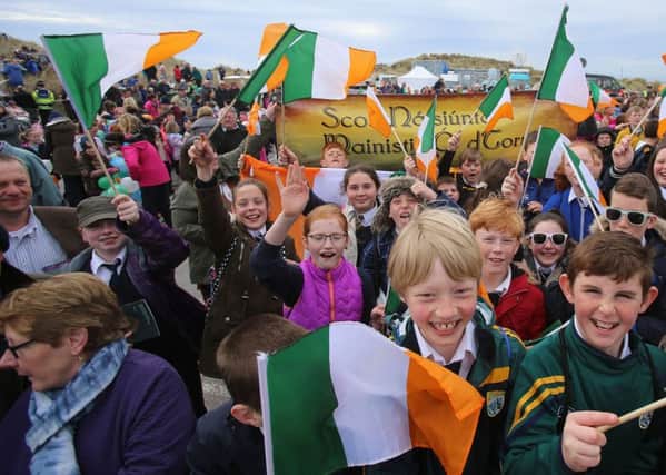 School children wave flags for a ceremony at Banna Strand in Co Kerry to mark the centenary of the capture and execution of Sir Roger Casement. PRESS ASSOCIATION Photo. Picture date: Wednesday April 20, 2016. SPhoto credit should read: Niall Carson/PA Wire