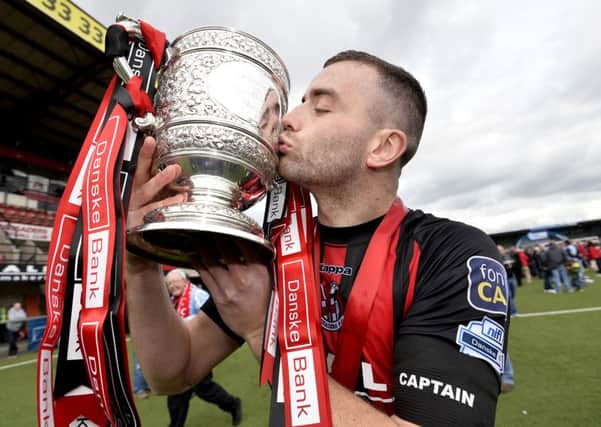 Crusaders Colin Coates celebrates with the Gibson Cup