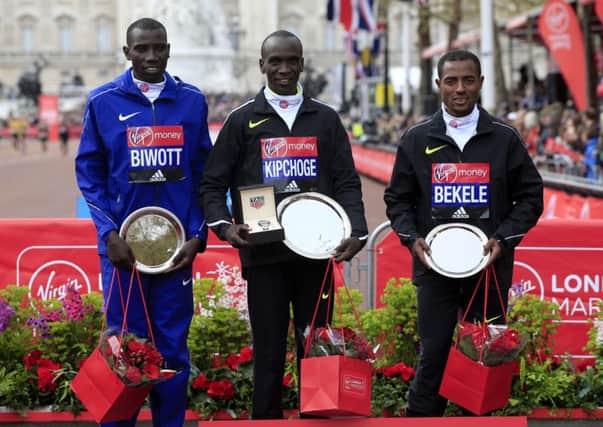 Gold medalist Kenya's Eliud Kipchoge (centre) silver medalist Kenya's Stanley Biwott (left) and bronze medalist Ethiopia's Kenenisa Bekele