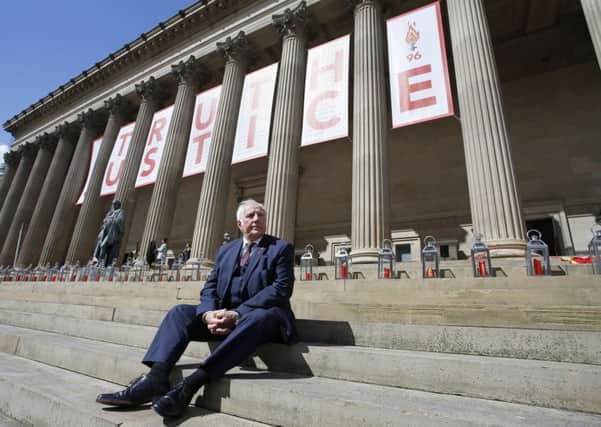 Trevor Hicks, whose daughters Sarah and Vicki died in the Hillsborough disaster, sits on the steps of St George's Hall in Liverpool, where there is a giant banner and candle lit for each of the 96 Liverpool fans who died as a result of the Hillsborough disaster, as they will be commemorated later after an inquest jury ruled they were unlawfully killed, triggering calls for further action. Photo: Peter Byrne/PA Wire