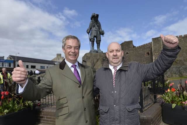 Noel Jordan of UKIP, with UK party leader Nigel Farage, in front of a statue of William of Orange outside Carrickfergus Castle