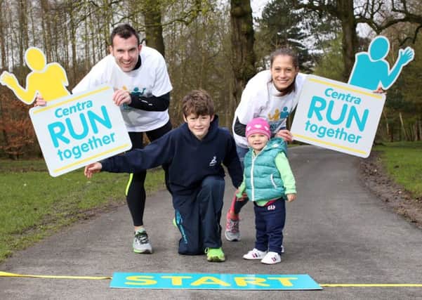 World Masters 800m champion Kelly Neely, from Lisburn, gets a little help from husband Ian, 18 month daughter Sarah and 13 year old Oliver Gilmore from Saintfield to launch a new series of fun runs across Northern Ireland