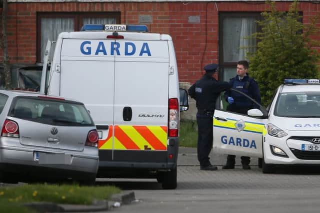 Gardai at the scene in Kilcronin Close, west Dublin, where a man, aged in his 30s, was gunned down in a gangland-style killing, about two hours after a suspected dissident republican was murdered in his pub