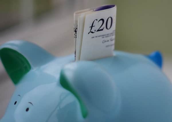 File photo dated 06/01/15 of money in a piggy bank, as one in seven adults still keeps cash in a piggy bank - while some are also stashing money in ornaments, empty margarine tubs, teapots or even in the freezer, a survey has found
