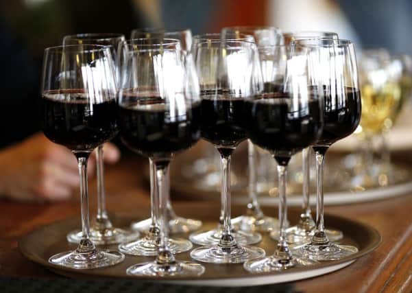 A tray of glasses of red wine