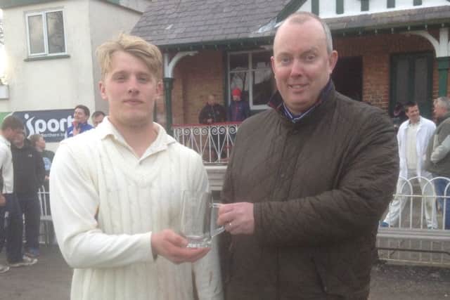 Donaghcloney's Robert Lyttle receives the Arthur J Gallagher Man of the Match award from the sponsor's Gordon Markey