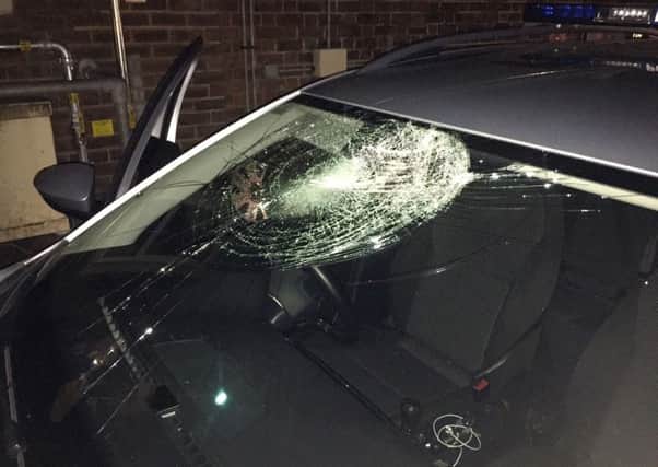Photo issued by PSNI of the damage done to a police car after the two officers inside came under attack by a masked man with a brick in Carrickfergus