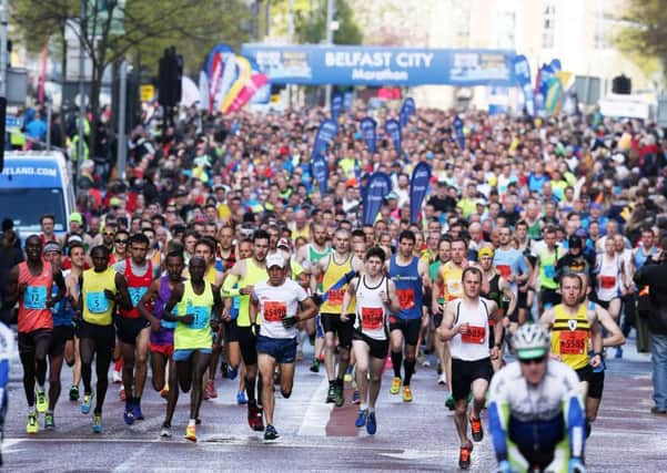 The runners head off along Chichester Street at the start of the RiverRock Belfast City Marathon. Picture by Darren Kidd / PressEye