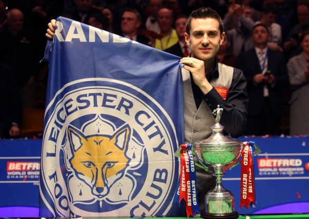 Mark Selby celebrates with the trophy after beating Ding Junhui in the final