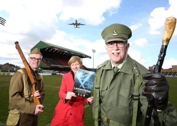 George Best Belfast City Airport has partnered Glentoran Community Trust to commemorate the 1941 Blitz.  In uniform at the Oval are GCT members Ray Cordner and Stephen Beattie, with Margaret Curliss of Belfast City Airport. Picture: Darren Kidd / Press Eye.