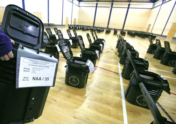An electoral office of Northern Ireland worker helps store ballot boxes ready for distribution for tomorrows election vote at an election centre in Co Antrim