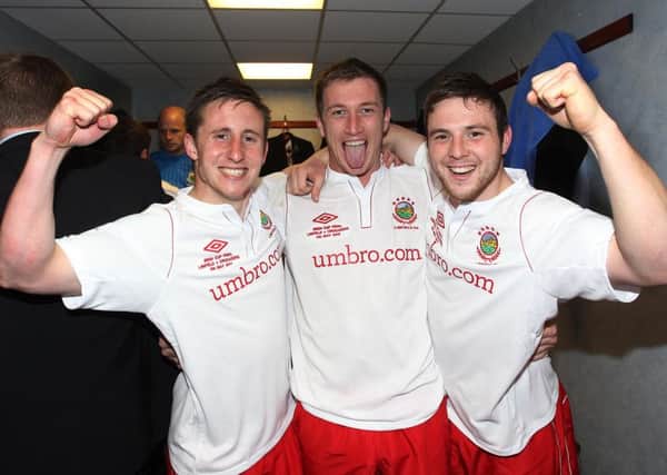 Jamie Mulgrew (right) celebrates Linfields 2012 Irish Cup win with Michael Carvill (left) and Mark McAllister (centre)