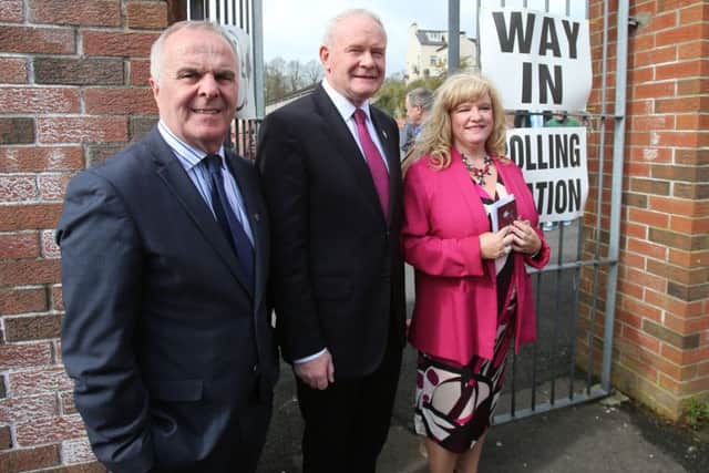 Sinn Fein candidates for Foyle (from the left) Raymond McCartney, Martin McGuinness and Maeve McLaughlin arrive at a polling station at Model Primary School in Londonderry