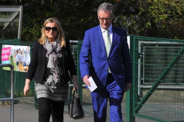 UUP Leader Mike Nesbitt arrive's  with his wife Lynda at Gilnahirk Primary School to make his vote on Polling day