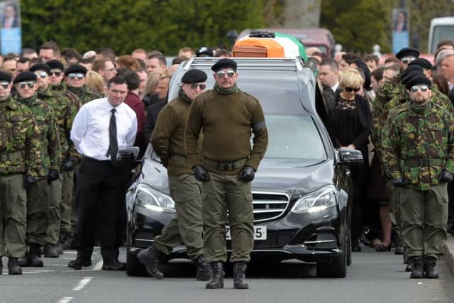 A guard of honour flanks the coffin of Michael Barr at his funeral in Strabane Co Tyrone this morning