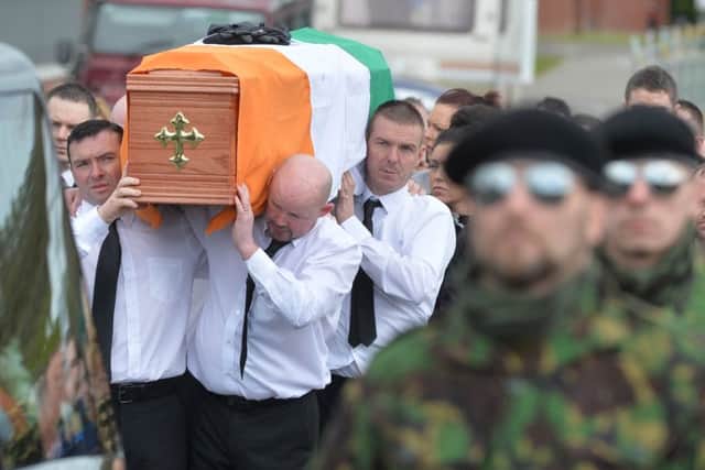 A guard of honour flanks the coffin of Michael Barr at his funeral in Strabane Co Tyrone this morning