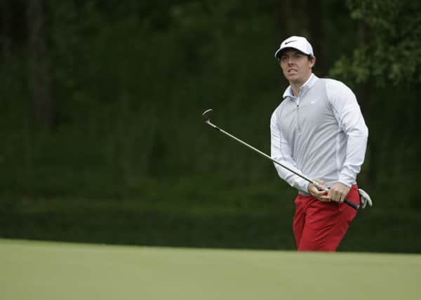 Rory McIlroy watches a chip shot at the 12th hole