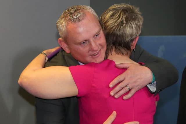 John McCallister is consoled by the SDLP's Margaret Ritchie after losing his Assembly seat