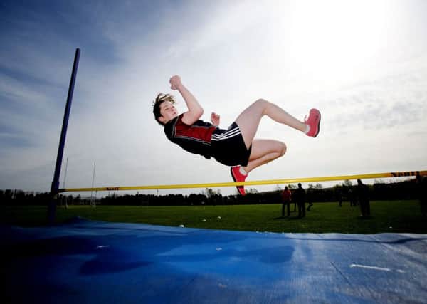 Fiona Leneghan from Aquinas school high-jumps at Cherryvale Playing Fields