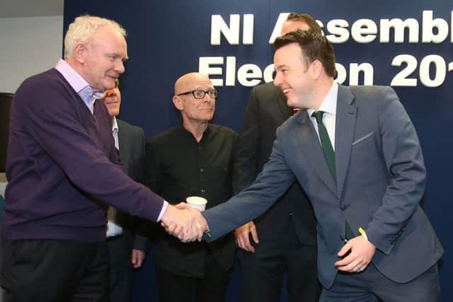 Martin McGuinness and Colum Eastwood  shake hands at the Foyle count, while People Before Profits Eamonn McCann watches on, having taken an SDLP seat there while his party took a Sinn Fein seat in West Belfast. Photo: Niall Carson/PA Wire