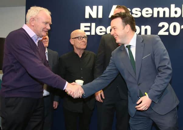 Martin McGuinness and Colum Eastwood  shake hands at the Foyle count, while People Before Profits Eamonn McCann watches on, having taken an SDLP seat there while his party took a Sinn Fein seat in West Belfast. Photo: Niall Carson/PA Wire