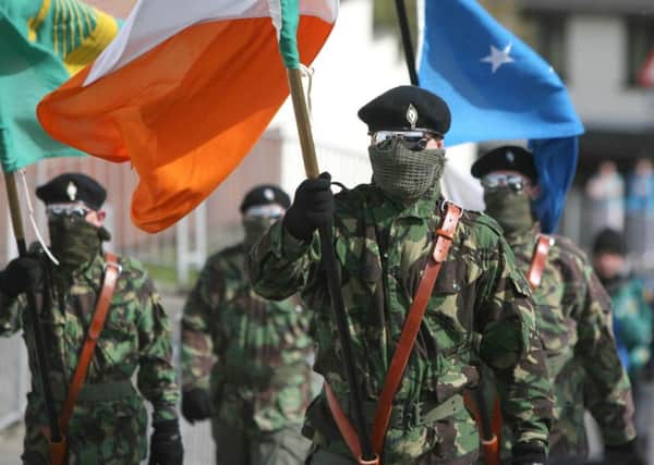 2010: Masked members of the Real IRA at a Republican Easter commemoration ceremony at Creggan cemetery, Londonderry