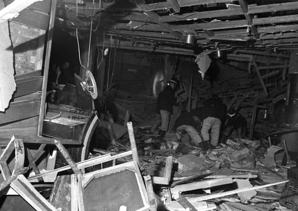 Firemen searching through the debris of the Birmingham pub bombings in 1974