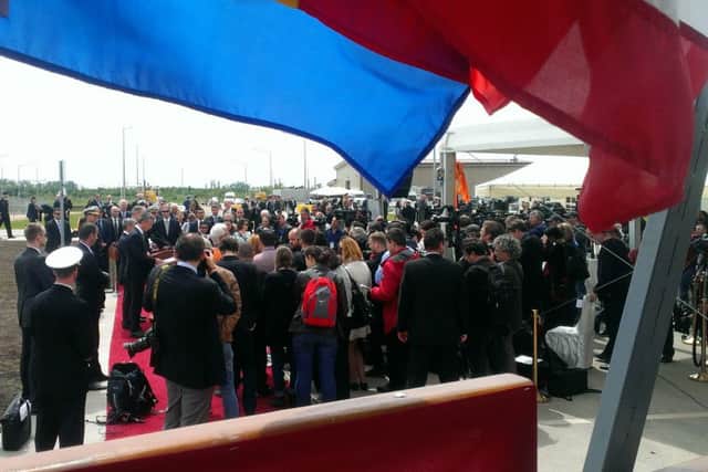 Seen through fluttering Romanian and United States flags, Nato's secretary general, Jens Stoltenberg (standing at lecturn, looking down) talks to international reporters from Devesulu military base in Romania after the unveiling of a major new missile defence facility.  Picture by Ben Lowry May 12 2016