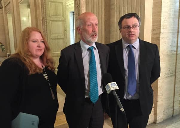 Alliance leader David Ford (centre), with MLAs Naomi Long  and Stephen Farry, speaks to the media at Stormont