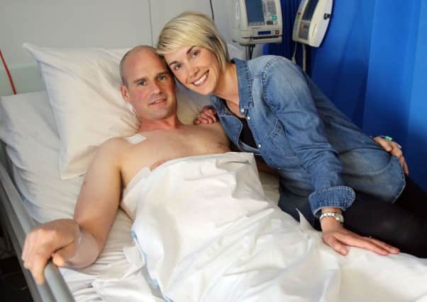 Ryan Farquhar with his wife Karen by his bedside in the Royal Victoria Hospital, Belfast.