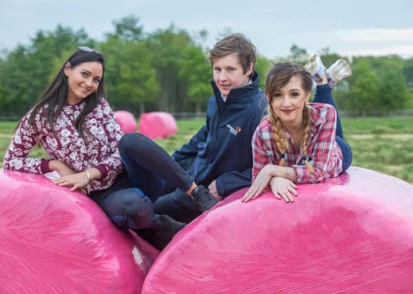 James Cunningham, Glanbia Agribusiness joined local girls Megan Conway and Deimante Poviliunaite to launch  the Glanbia Agribusiness 'Bale Pink appeal in Co Kilkenny. Visit www.glanbiaconnect.com to find your nearest branch to purchase the netwrap.