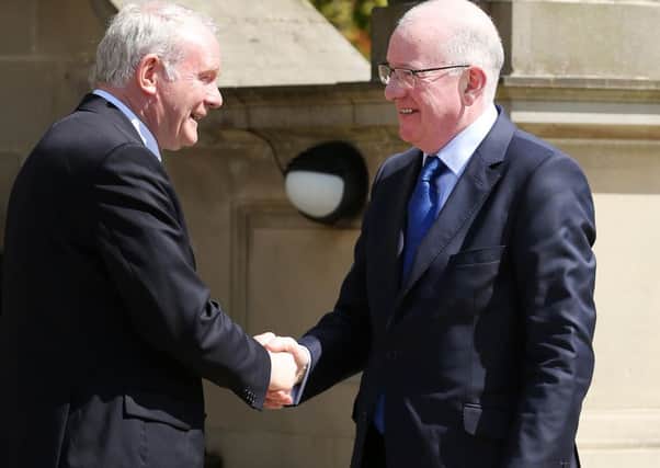 Handout photo issued by Press Eye of Deputy First Minister Martin McGuinness (left) greeting Foreign Affairs Minister Charlie Flanagan at Stormont Castle in Belfast