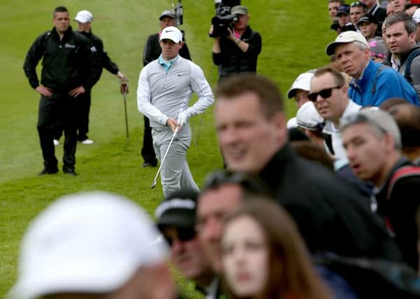 Rory McIlroy watches his second shot on the 5th hole