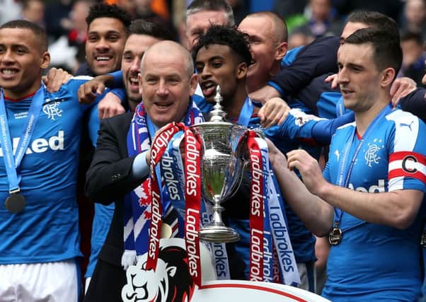 Rangers manager Mark Warburton  (centre) and Rangers' Lee Wallace with the Ladbrokes Scottish Championship trophy
