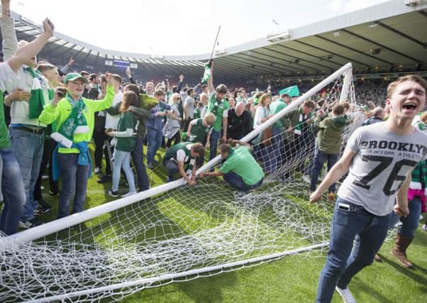Hibernian fans invade the pitch after the William Hill Scottish Cup Final