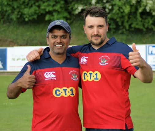 Kaushik Aphale and Craig Lewis celebrate their brilliant hundreds for Derriaghy yesterday.