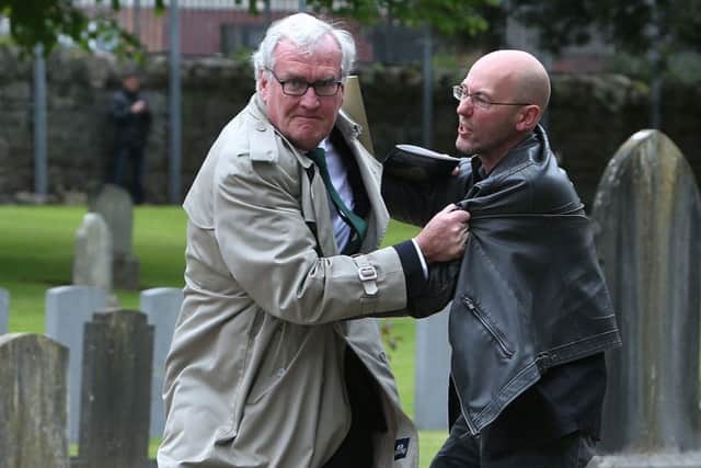 Canadian Ambassador to Ireland Kevin Vickers wrestles with a protester (right) during the ceremony at Grangegorman. Photo: Brian Lawless/PA Wire