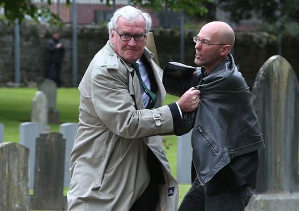 Canadian Ambassador to Ireland Kevin Vickers wrestles with a protester (right) during the ceremony at Grangegorman. Photo: Brian Lawless/PA Wire