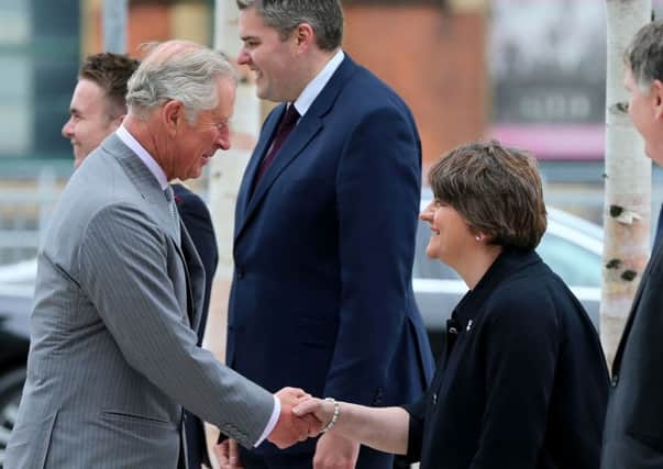 Northern Ireland First Minister Arlene Foster curtseys for The Prince of Wales as he arrives at the Northern Ireland Science Park at Queen's University Belfast, where he officially launched the University's first Global Research Institute
