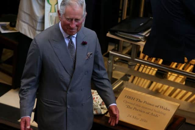 The Prince of Wales unveils a plaque to officially open the Portico Arts Centre in Portaferry, Northern Ireland