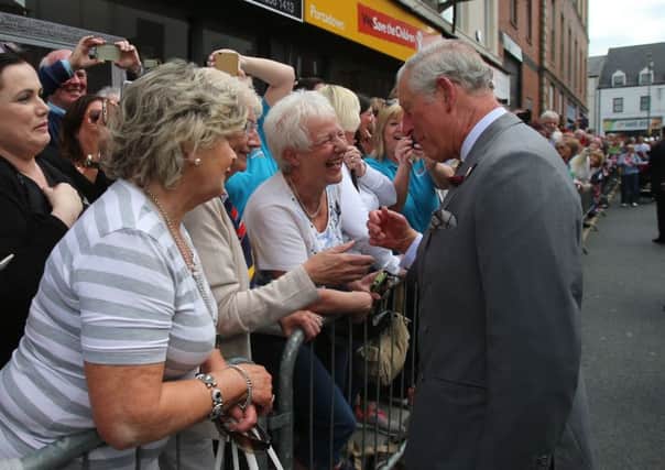 The Prince of Wales meets local people during a visit to the Yellow Door Deli at Portadown in Northern Ireland yesterday