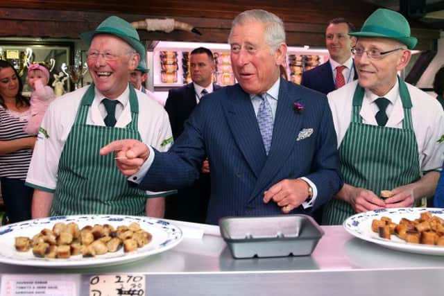 The Prince of Wales samples award-winning sausages made by brothers Diarmuid (left) and Ernan McGettigan at McGettigan's butcher's shop in Donegal Town, as Charles visits the Republic of Ireland in the latest royal bid to solidify transformed Anglo-Irish relations