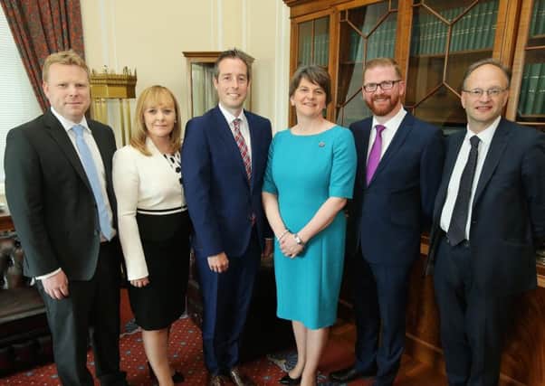 First Minister Arlene Foster (third right) with new DUP ministers Alastair Ross, Michelle McIlveen, Paul Givan, Simon Hamilton and Peter Weir